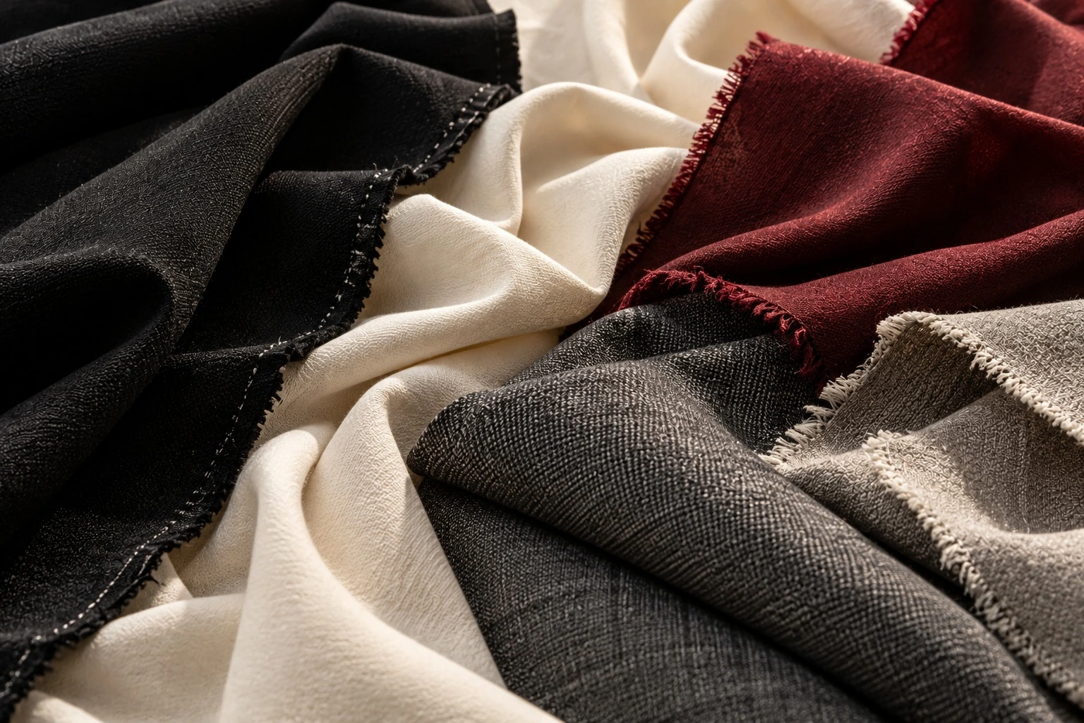 Folded blue, coral and ochre cloth in changing light.